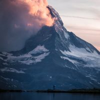 photo of person standing across the mountain
