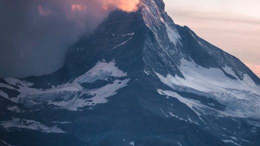 photo of person standing across the mountain